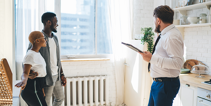 Couple discussing potential apartment with multifamily property manager